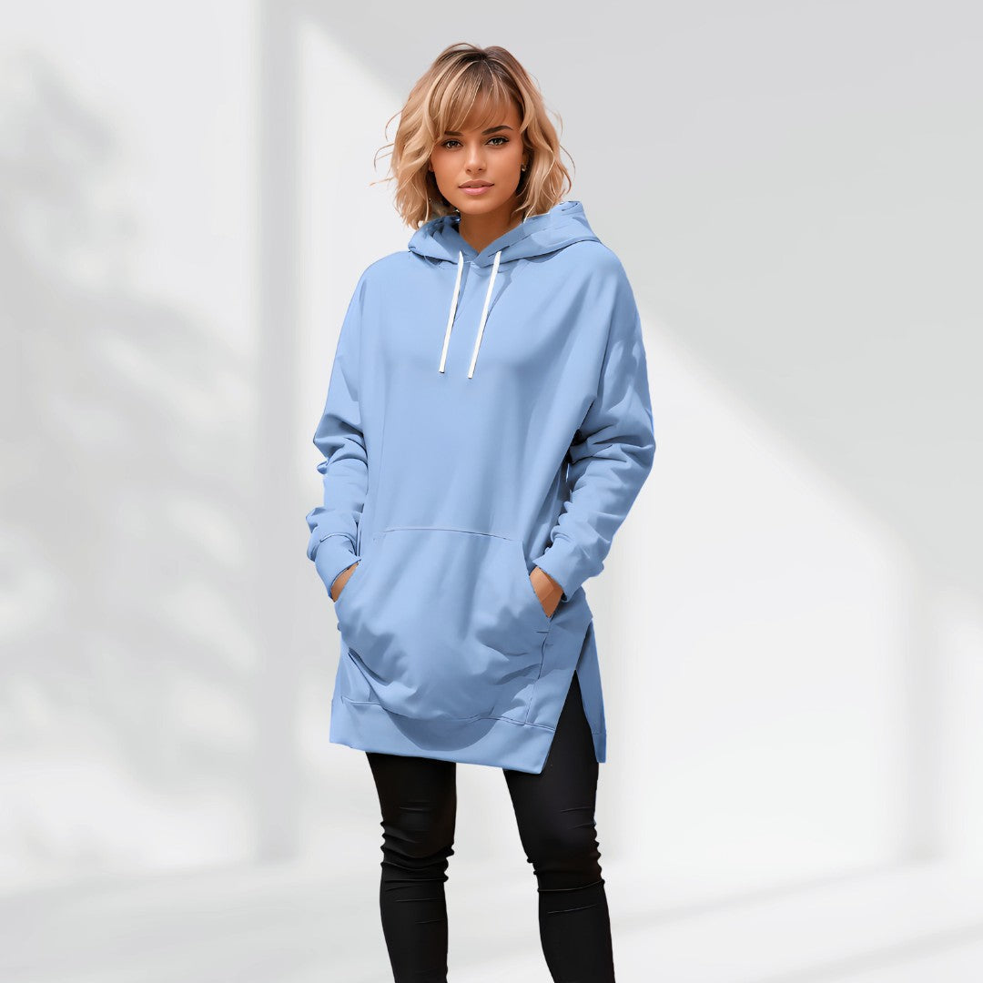 Woman wearing a baby blue hoodie dress, standing and facing forward to show the fit and style.