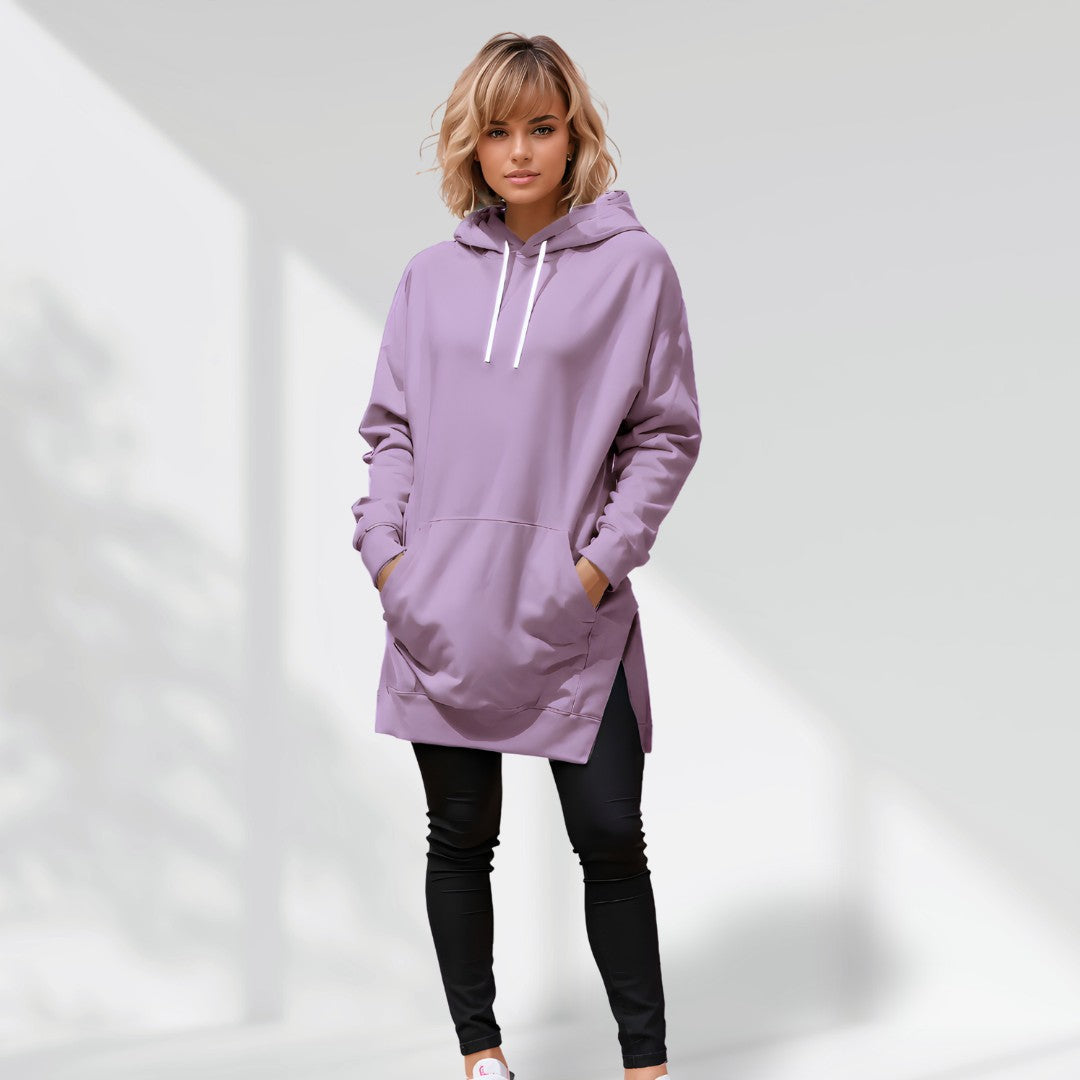 Woman wearing a purple hoodie dress, standing and facing forward to show the fit and style.