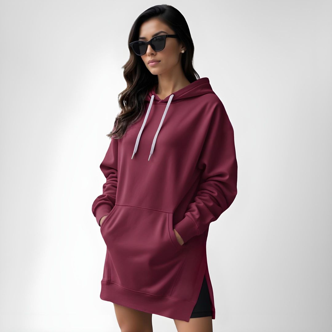 Woman wearing a red hoodie dress, standing and facing forward to show the fit and style