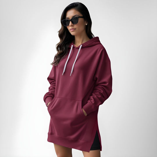 Woman wearing a red hoodie dress, standing and facing forward to show the fit and style